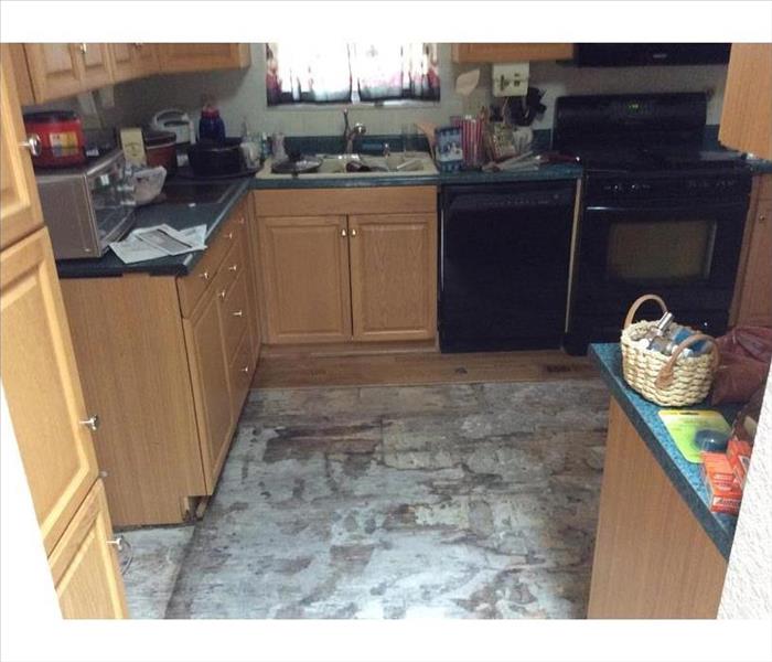 Water damaged kitchen with finished flooring removed