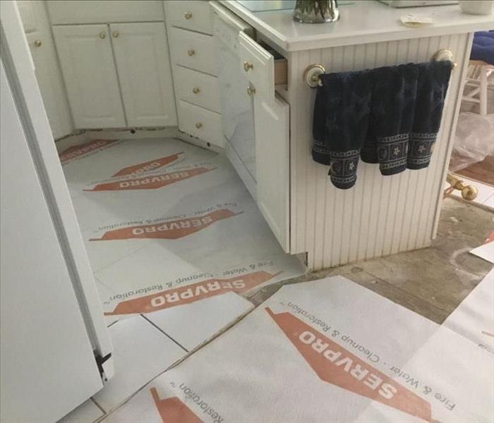  Kitchen with SERVPRO protective paper covering on the exposed subfloor 