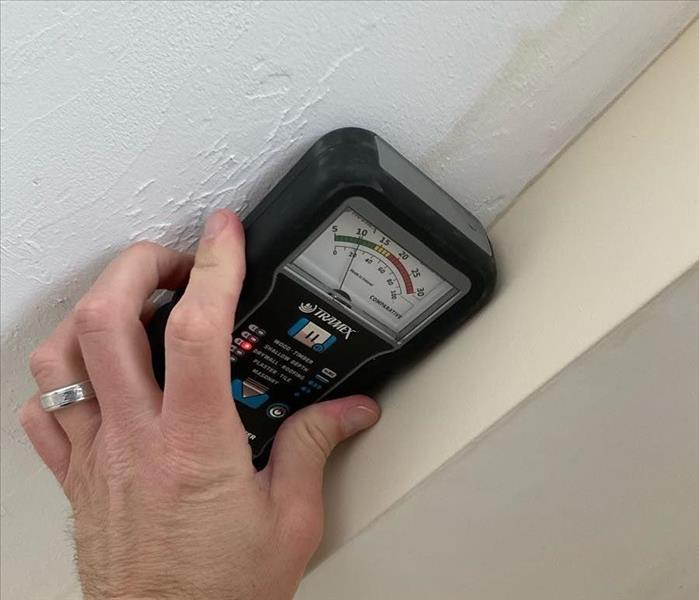 A SERVPRO technician evaluating drywall with a correctly-calibrated Tramex pinless moisture sensor