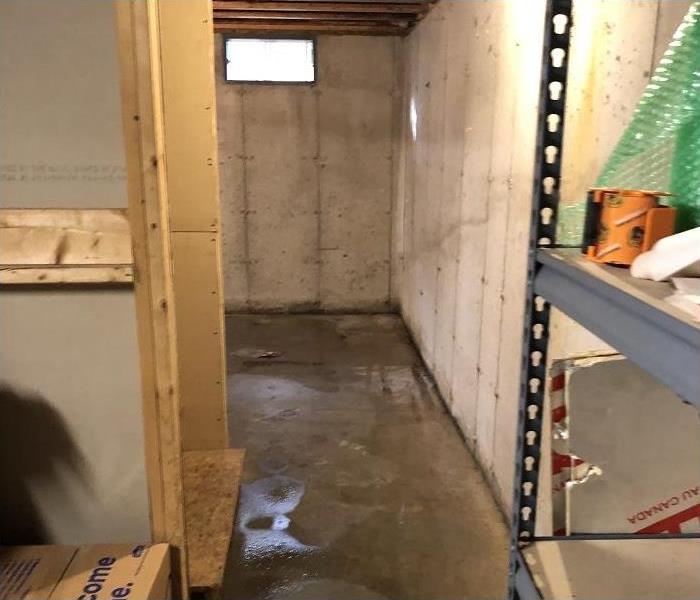 water damaged basement, water remaining on concrete floor